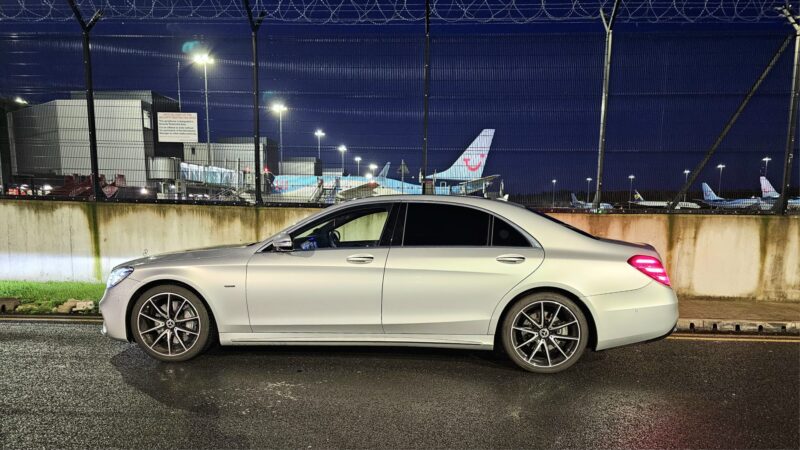 Silver Mercedes UK Parked Outside Airport - Safe Travels VIP Chauffeur Services